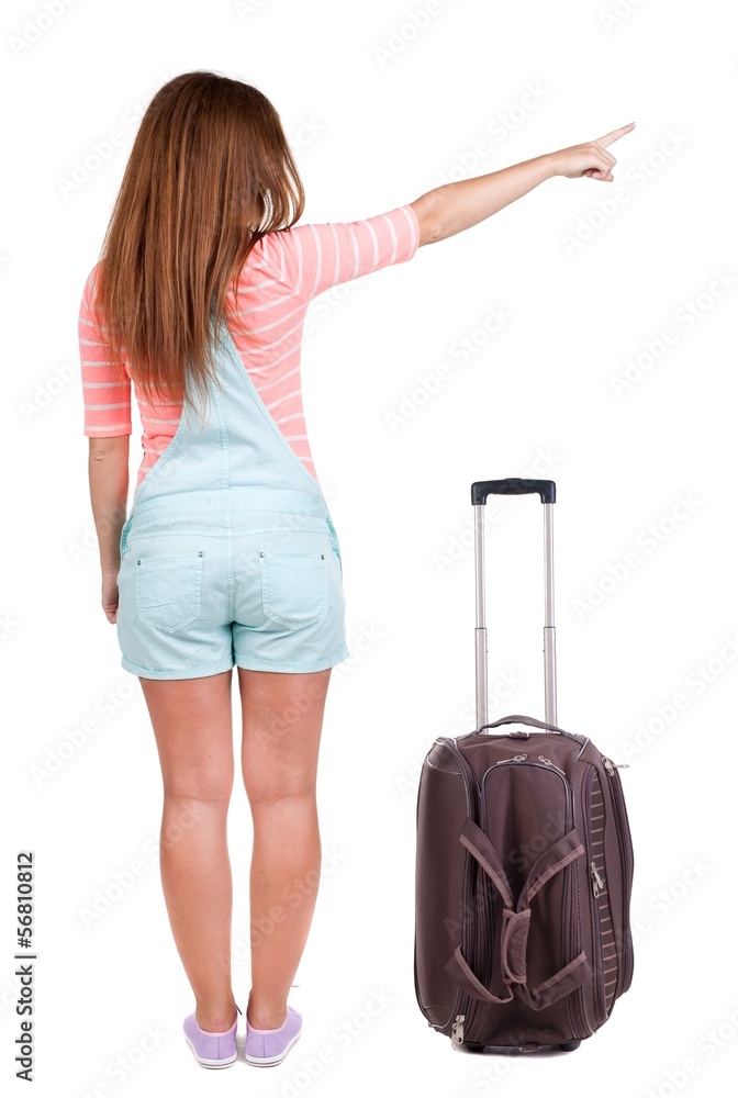 Back view of traveling pointing woman with suitcase Back view of traveling pointing woman with suitcase