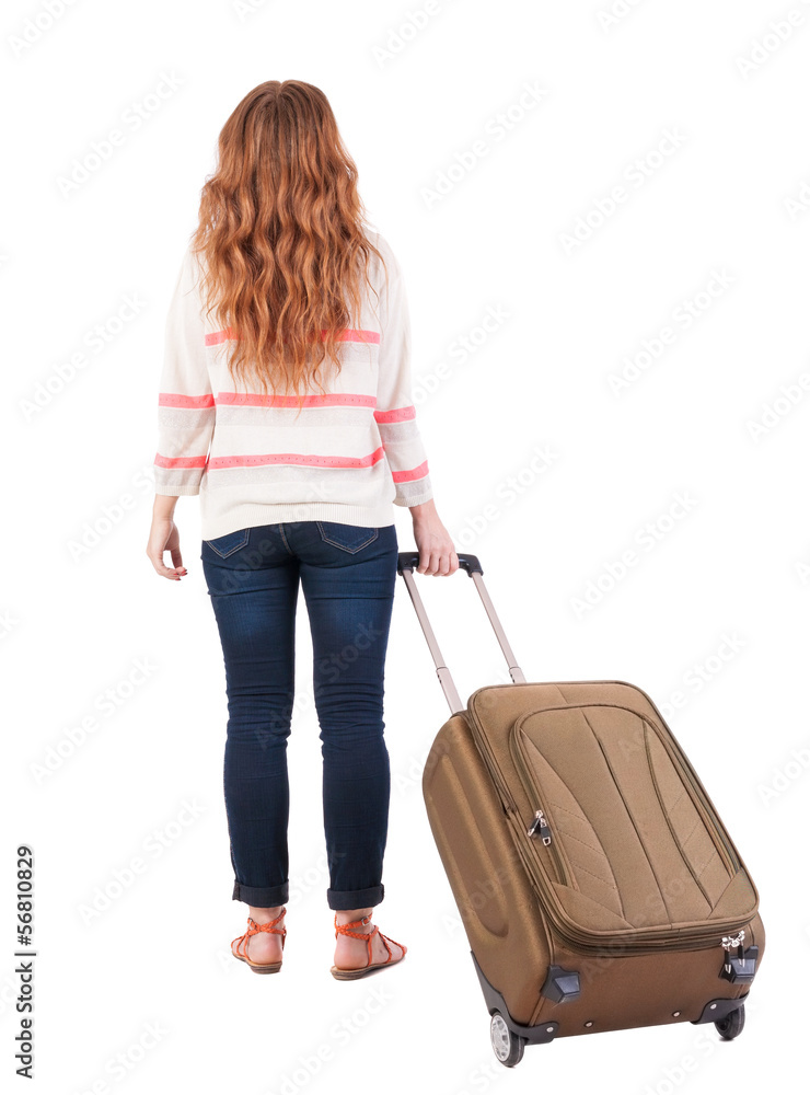 back view of walking woman with suitcase. back view of walking woman with suitcase.