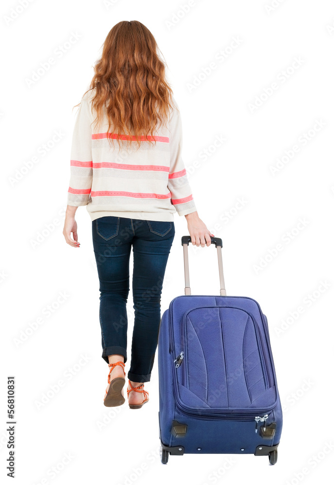 back view of walking woman with suitcase. back view of walking woman with suitcase.