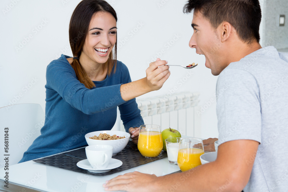 Young Couple Enjoying Breakfast in the kitchen