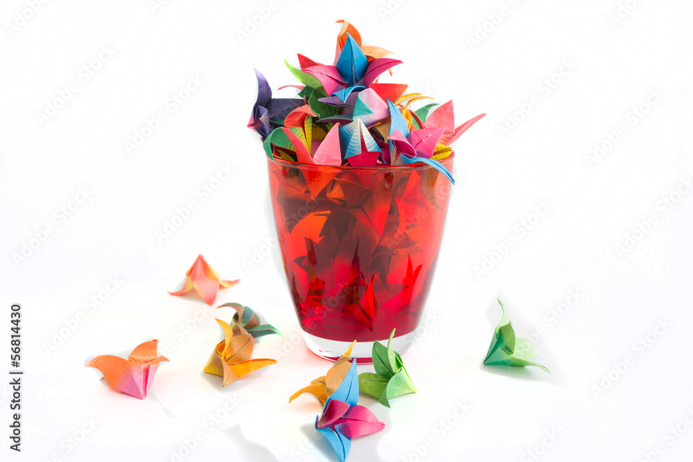 Obraz premium Red glass and flowers paper on a white background