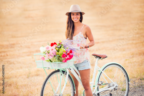 Beautiful young woman on bike