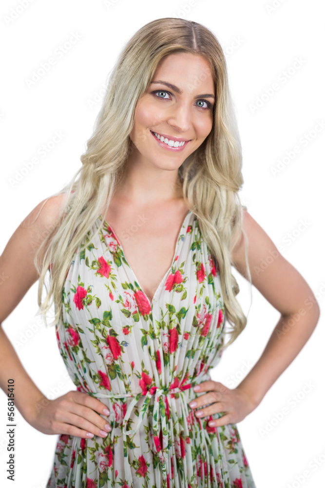 Smiling blonde wearing flowered dress posing Smiling blonde wearing flowered dress posing