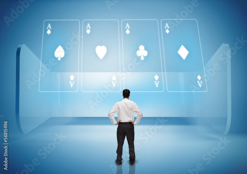 Rear view of businessman looking at holographic cards in blue li photo