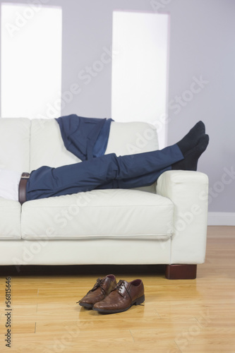 Close up of male legs in suit lying on couch © WavebreakmediaMicro