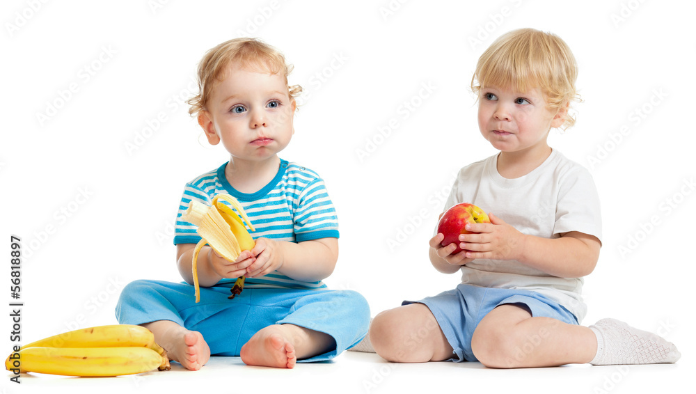 Two kids eating healthy food isolated on white Two kids eating healthy food isolated on white