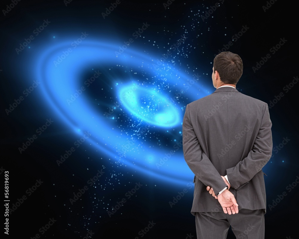Businessman standing with hands behind back Businessman standing with hands behind back