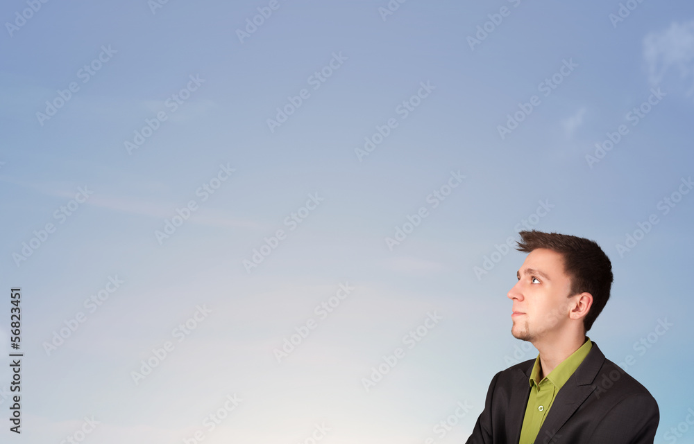 Handsome man looking at the blue sky copyspace