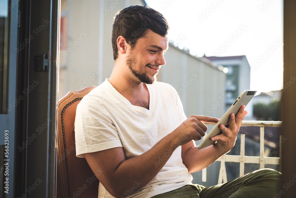 young stylish hipster man using tablet young stylish hipster man using tablet