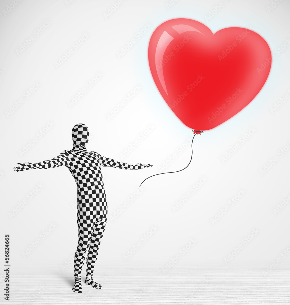Fototapeta premium Cute guy in morpsuit body suit looking at a balloon shaped heart