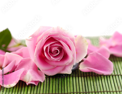 rose and pile of petals on green mat