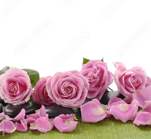 pink rose with zen stones on green mat