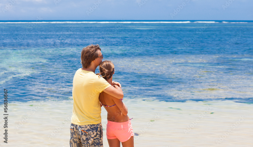 Couple walking and having fun on a tropical beach at Maldives Couple walking and having fun on a tropical beach at Maldives