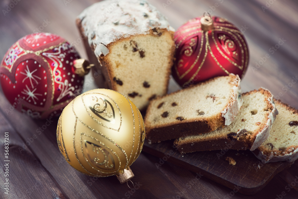 Sliced christmas cake and christmas baubles, horizontal shot Sliced christmas cake and christmas baubles, horizontal shot