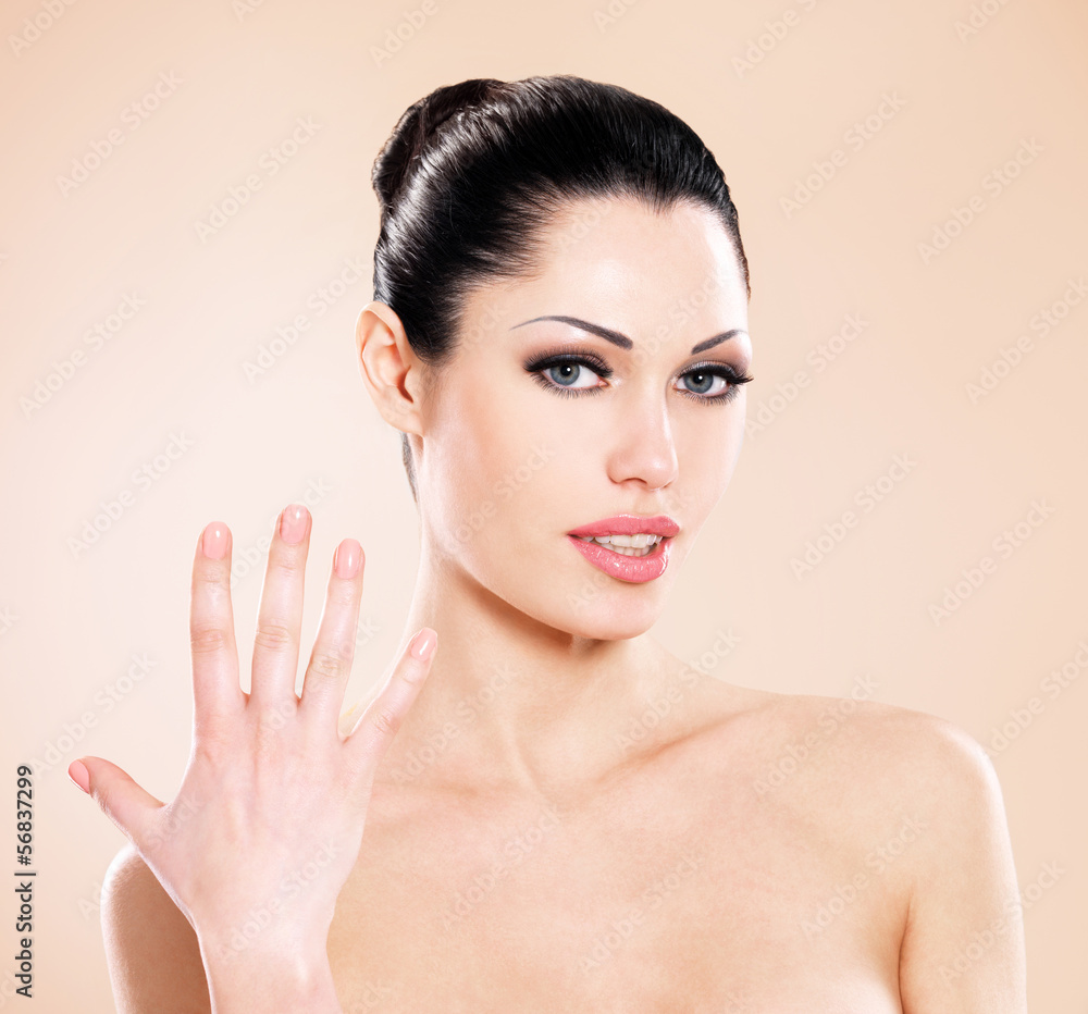 Fototapeta premium Beautiful woman with raised palm up