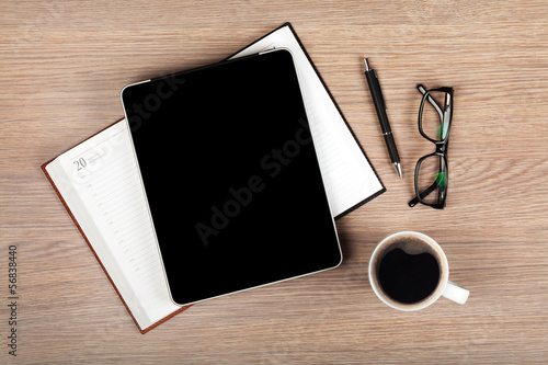 Tablet with blank screen and coffee cup