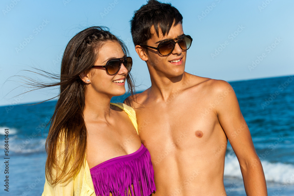 Handsome teen couple wearing sunglasses.
