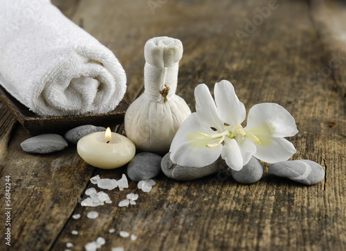 white orchid , stones ,candle ,towel on old wood background