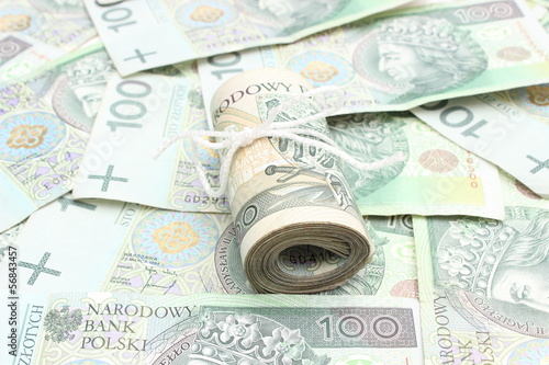 Roll of tied banknotes on money background