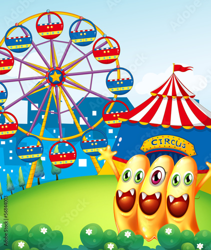 Three playful monster at the hilltop with a carnival