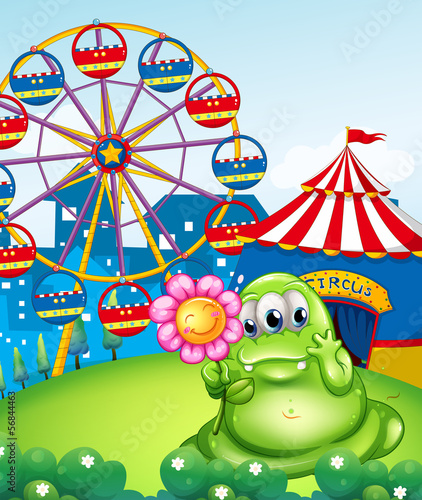 A monster holding a pink flower in front of the carnival