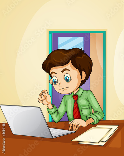 A businessman using the laptop inside the room