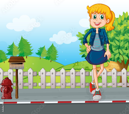 A tall young woman at the street standing near the mailbox