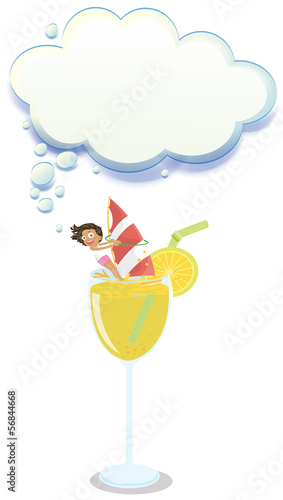 A young girl enjoying above the glass of juice with an empty clo