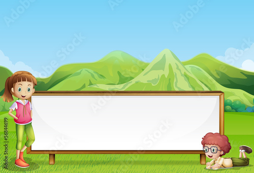 Kids at the field with a wide empty signboard