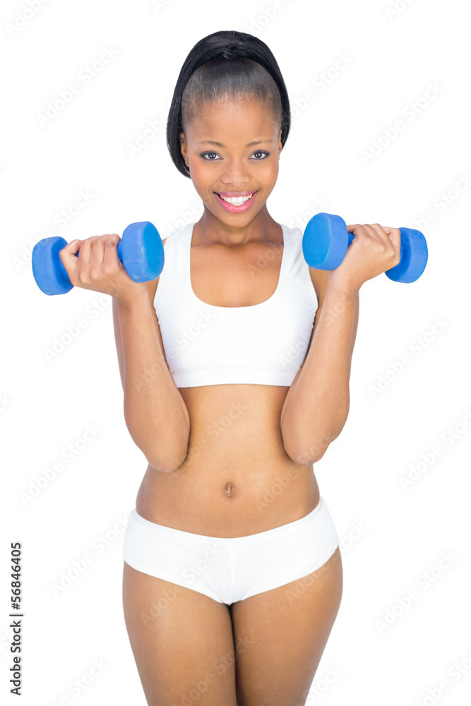 Fit smiling woman working out with dumbbells Fit smiling woman working out with dumbbells