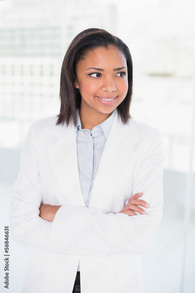 Pensive young dark haired businesswoman posing with arms crossed Pensive young dark haired businesswoman posing with arms crossed