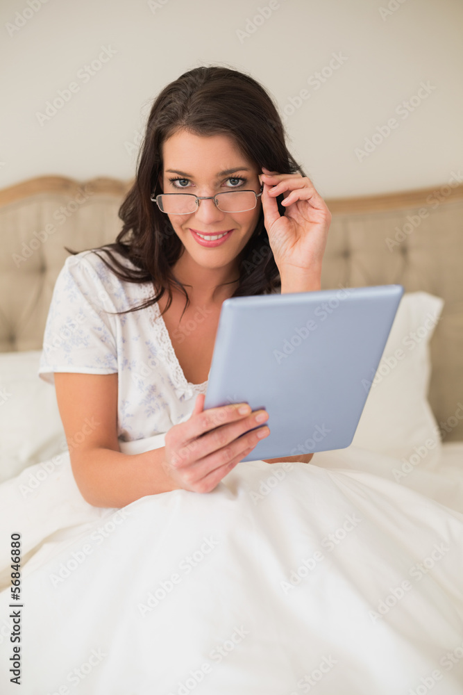 Happy pretty brown haired woman using a tablet pc Happy pretty brown haired woman using a tablet pc