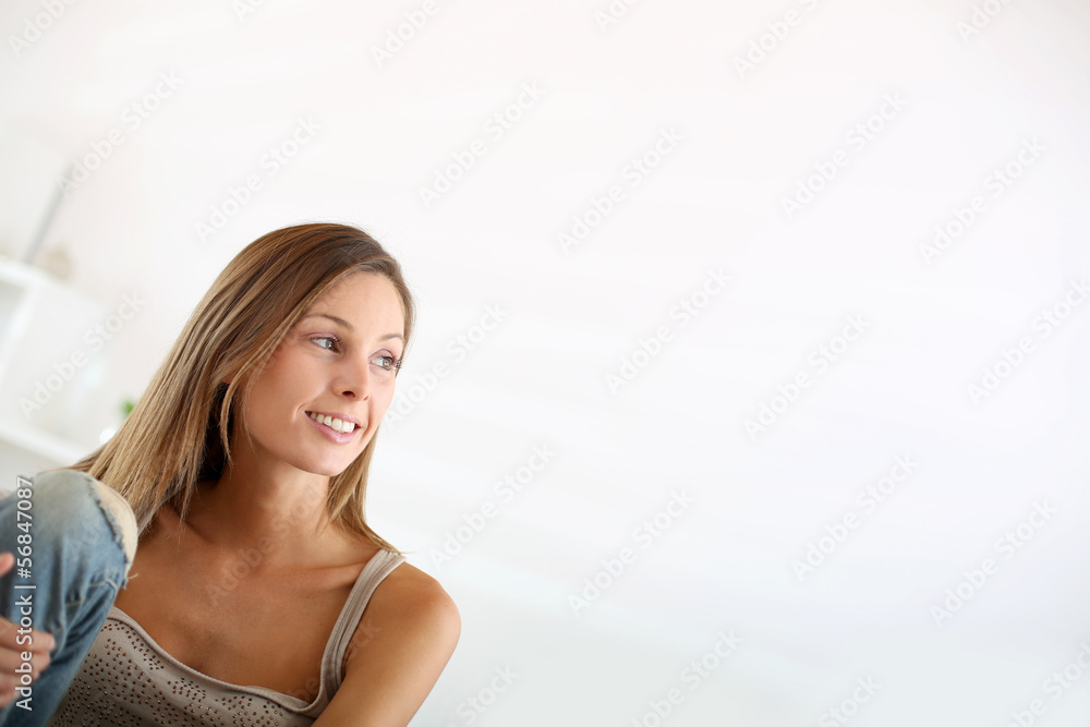 Beautiful young woman sitting in couch at home Beautiful young woman sitting in couch at home