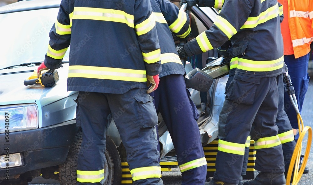 Firefighters and doctors helping the driver after car accident. Firefighters and doctors helping the driver after car accident.