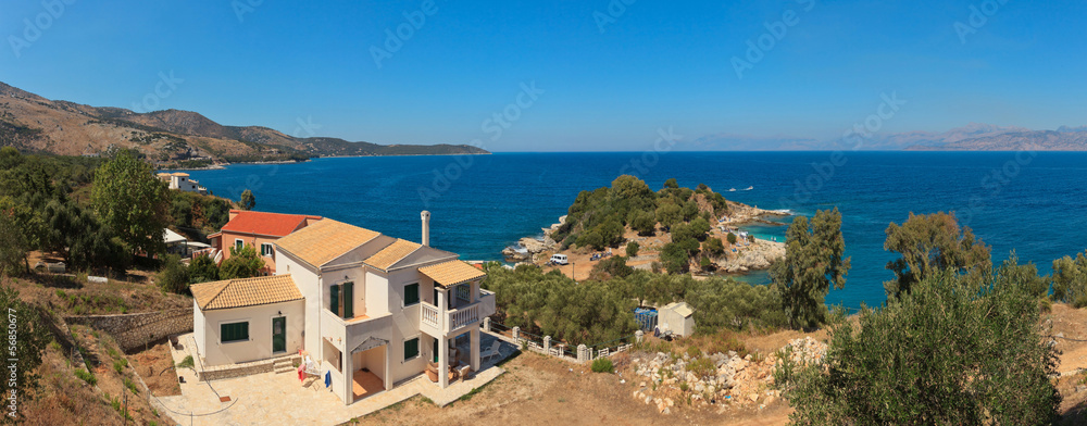Panoramic shot of a white house on the coast. Beautiful bay with