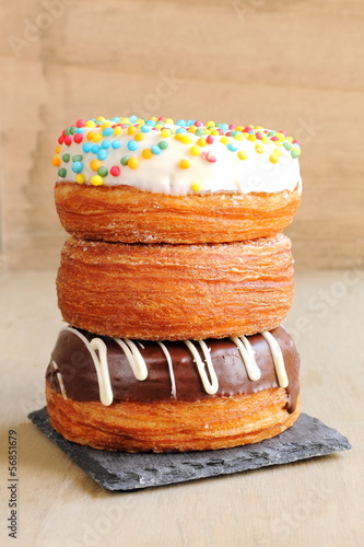 Trendy puff pastries, half croissant and half donut photo