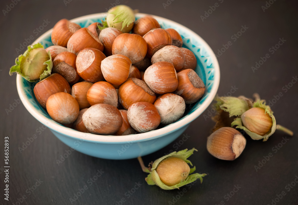 Hazelnuts with shell on the wooden table Hazelnuts with shell on the wooden table