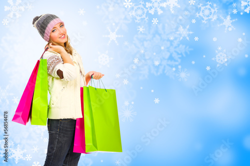Girl with bags on winter background