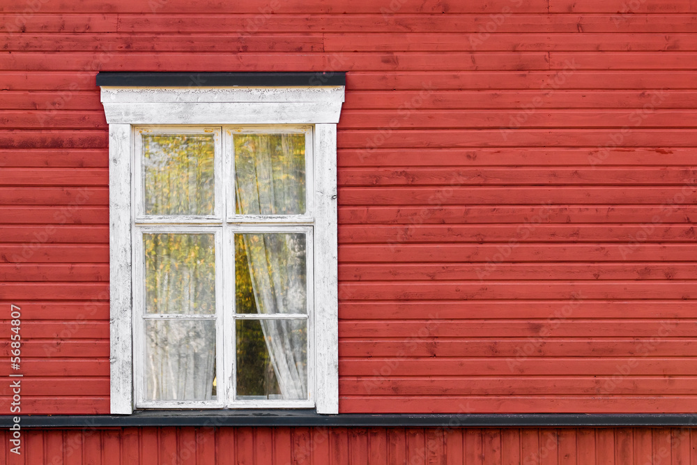 Old white window on red wooden wall
