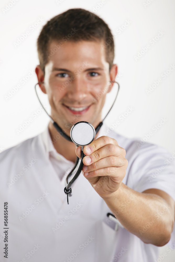 Young medical doctor man showing the stethoscope. Isolated. Young medical doctor man showing the stethoscope. Isolated.