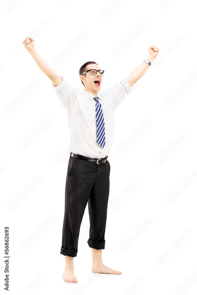 Excited barefooted guy with raised hands gesturing happiness Excited barefooted guy with raised hands gesturing happiness