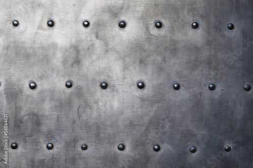 Black metal plate or armour texture with rivets photo