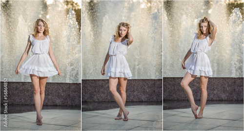 Bild auf Leinwand Attractive girl in white short dress sitting near a fountain