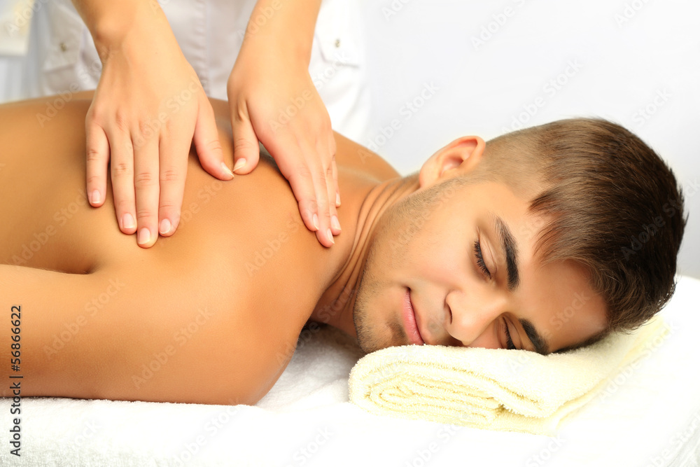 Young man having back massage close up Young man having back massage close up