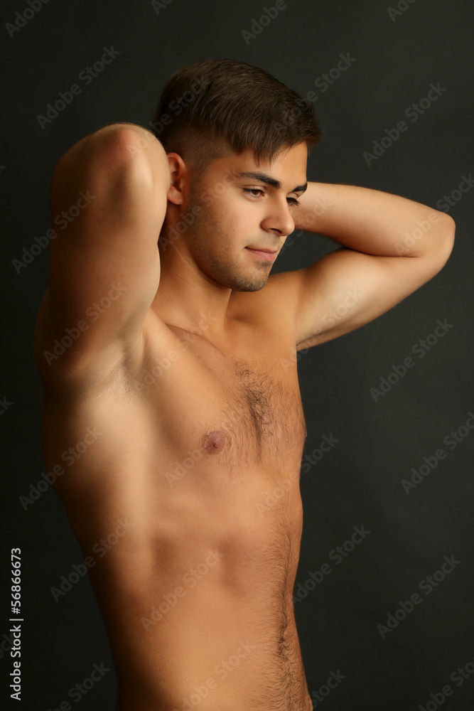 Portrait of muscle man on grey background Portrait of muscle man on grey background