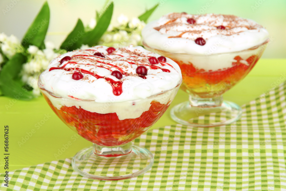 Tasty jelly in bowls on table on light background Tasty jelly in bowls on table on light background