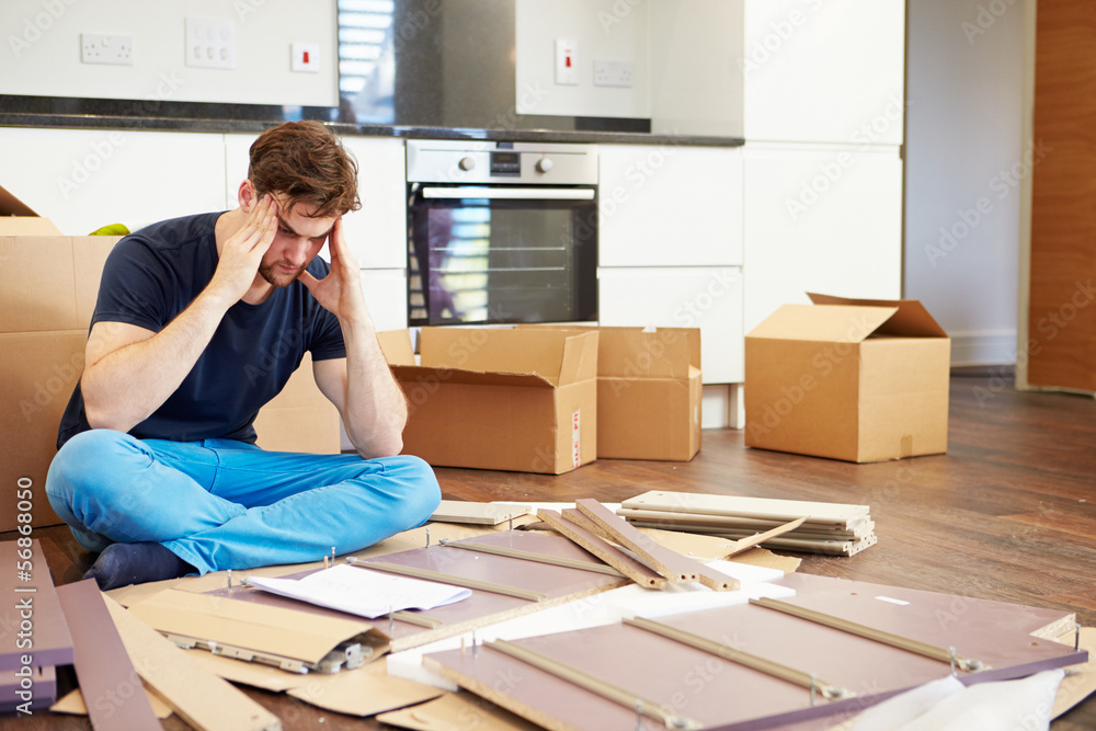 Frustrated Man Putting Together Self Assembly Furniture Frustrated Man Putting Together Self Assembly Furniture