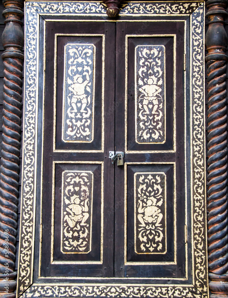 Ancient golden carving wooden window of Thai temple. Thailand