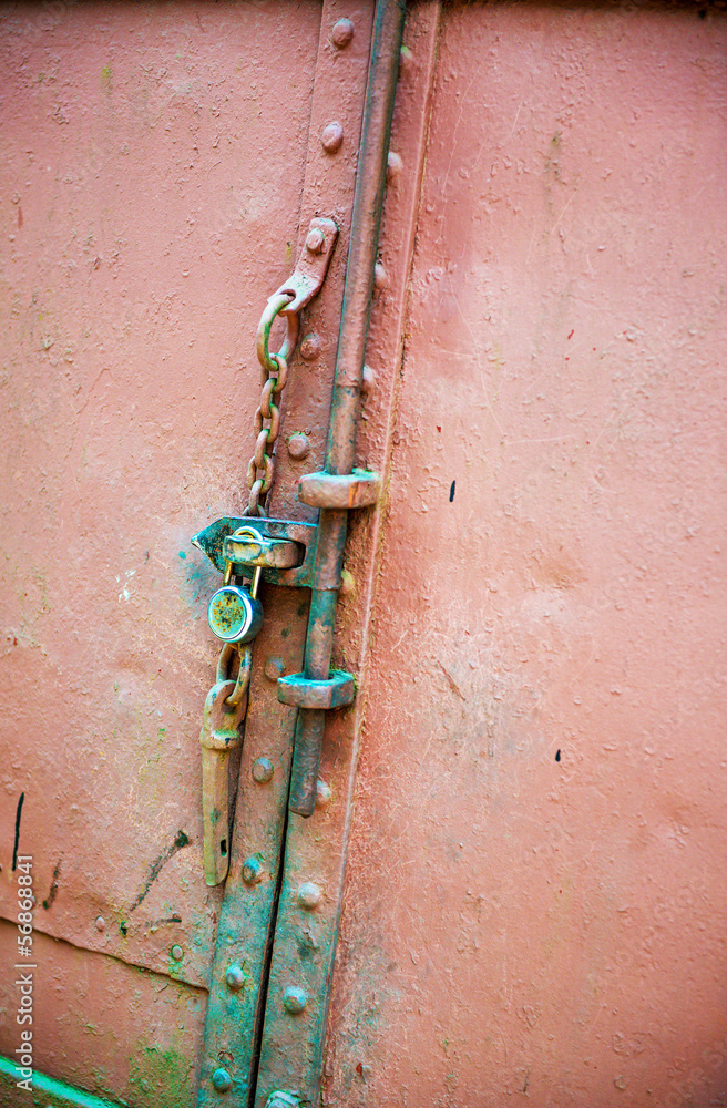 Weathered old door with lock and chain Weathered old door with lock and chain