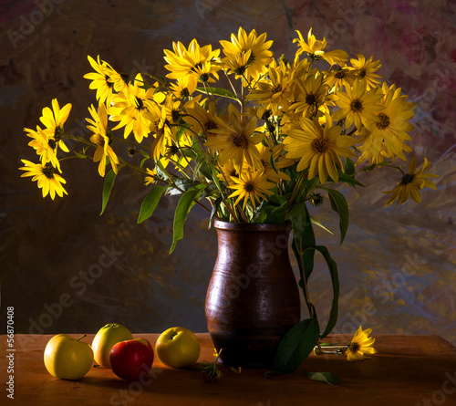 Bunch of bright yellow flowers (rudbeckia) in brown vase and app